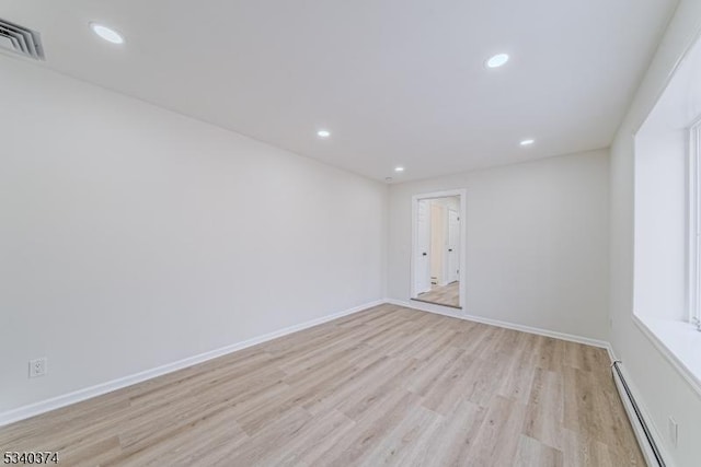 unfurnished room with recessed lighting, visible vents, baseboards, light wood-style floors, and baseboard heating