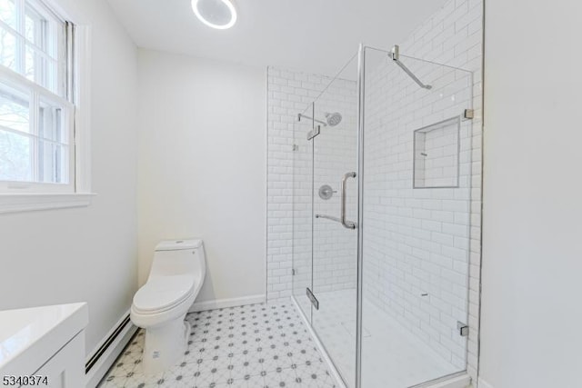 bathroom with toilet, a stall shower, plenty of natural light, and baseboard heating