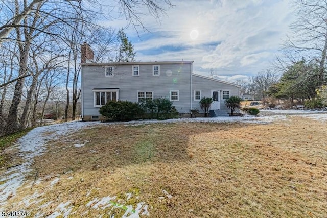 exterior space with a yard and a chimney