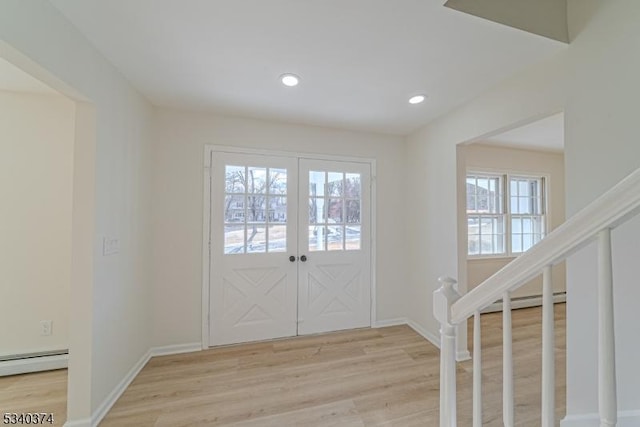 entrance foyer with light wood-style floors, recessed lighting, baseboard heating, and stairs