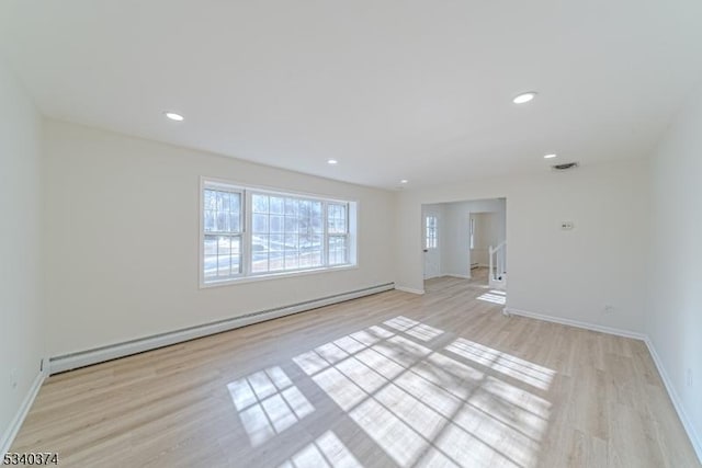 unfurnished room with a baseboard radiator, recessed lighting, visible vents, light wood-style floors, and baseboards