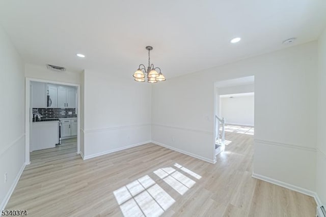 unfurnished dining area featuring light wood-type flooring, visible vents, a notable chandelier, and recessed lighting