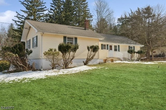 view of front of property featuring a chimney and a front lawn