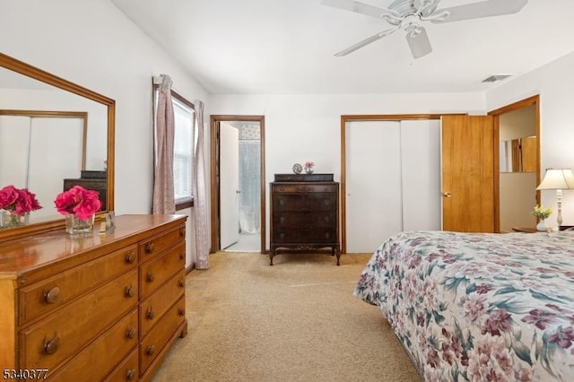 bedroom featuring visible vents, a closet, a ceiling fan, and light colored carpet