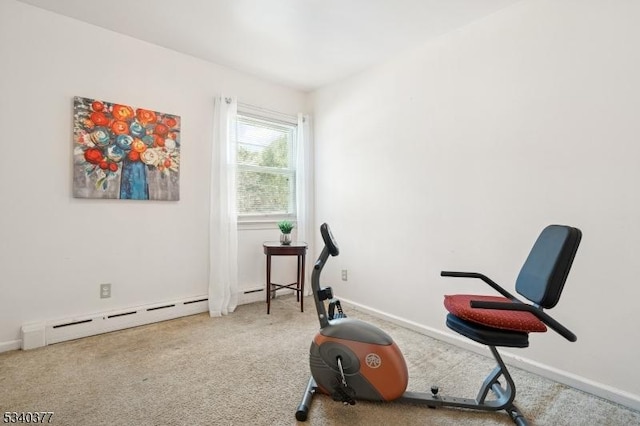 exercise area featuring a baseboard heating unit, baseboards, and light colored carpet