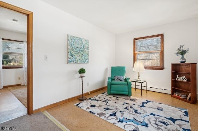 living area with baseboards and baseboard heating