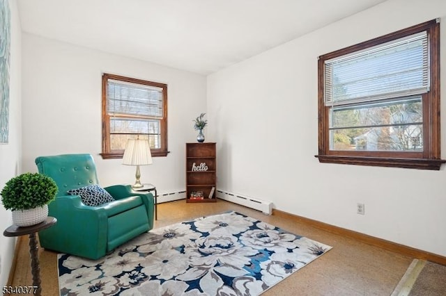 sitting room featuring baseboards and baseboard heating