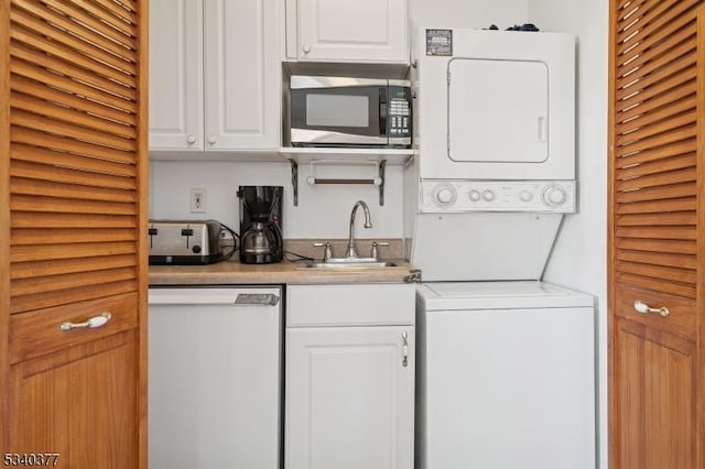 clothes washing area featuring laundry area, a sink, and stacked washing maching and dryer