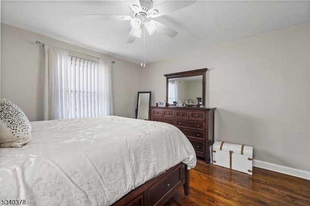 bedroom featuring ceiling fan, baseboards, and dark wood-style flooring