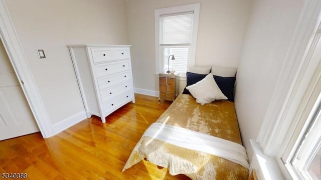 bedroom featuring light wood-type flooring and baseboards