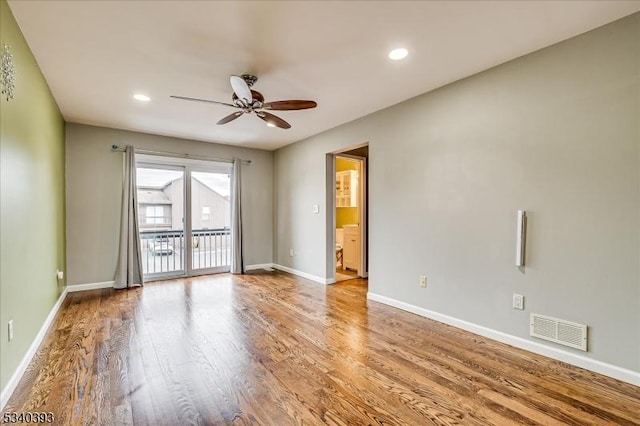 empty room featuring ceiling fan, recessed lighting, wood finished floors, visible vents, and baseboards