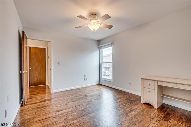 interior space featuring wood finished floors, a ceiling fan, and baseboards