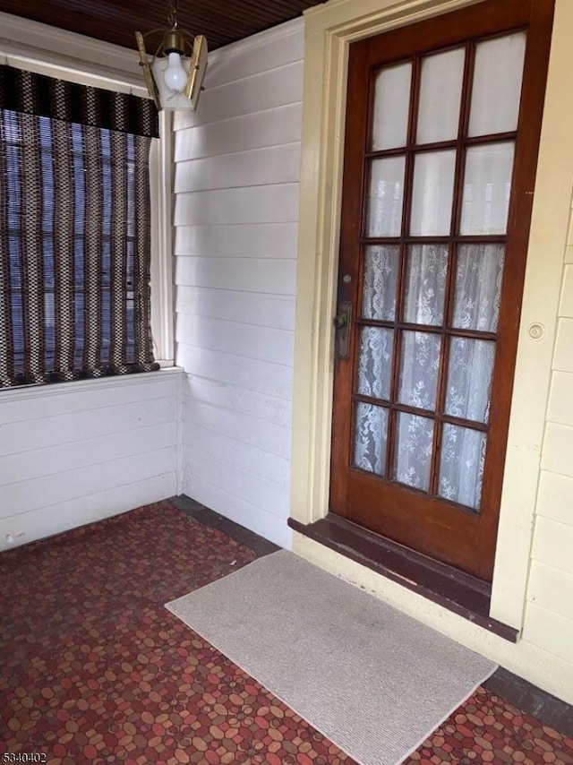 doorway to property with concrete block siding