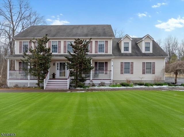 colonial home featuring a porch and a front yard