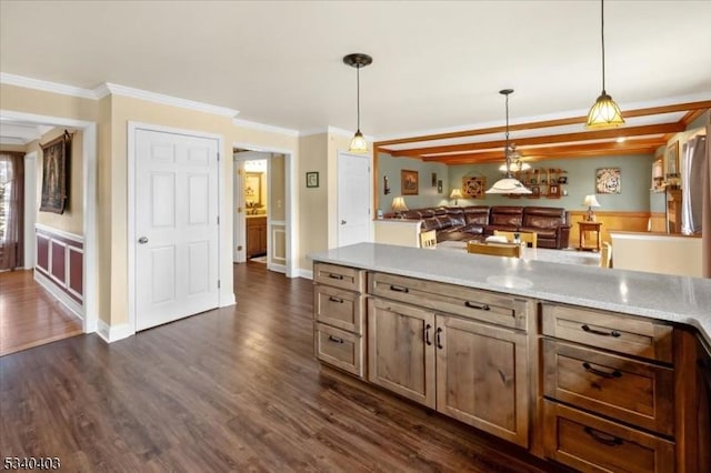 kitchen featuring ornamental molding, light countertops, decorative light fixtures, and dark wood finished floors