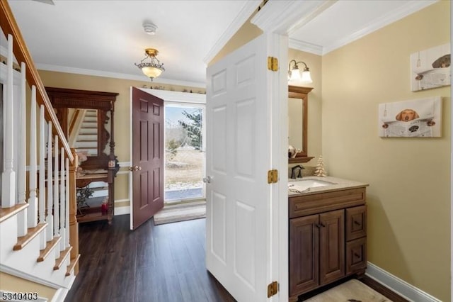 bathroom featuring ornamental molding, vanity, baseboards, and wood finished floors