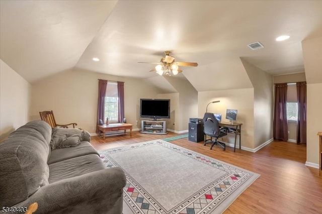 living area with recessed lighting, visible vents, vaulted ceiling, wood finished floors, and baseboards
