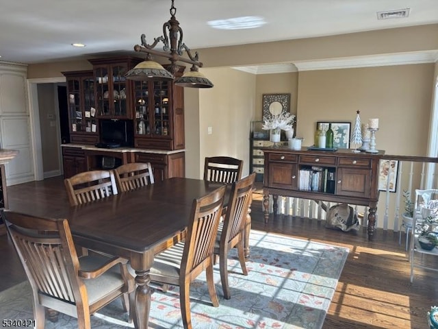 dining room featuring crown molding, wood finished floors, visible vents, and recessed lighting