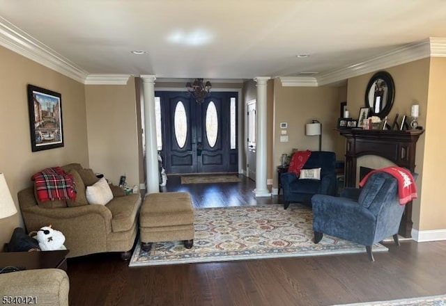 foyer entrance with decorative columns, crown molding, baseboards, and dark wood-style flooring