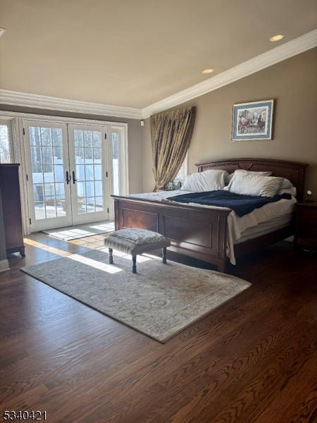 bedroom featuring french doors, ornamental molding, multiple windows, and access to exterior