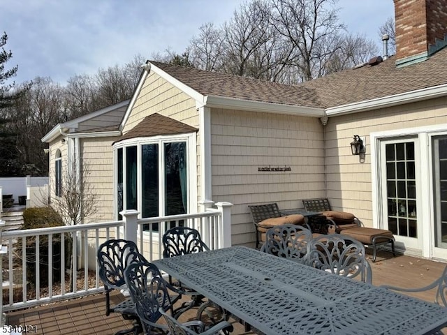 wooden deck featuring outdoor dining area