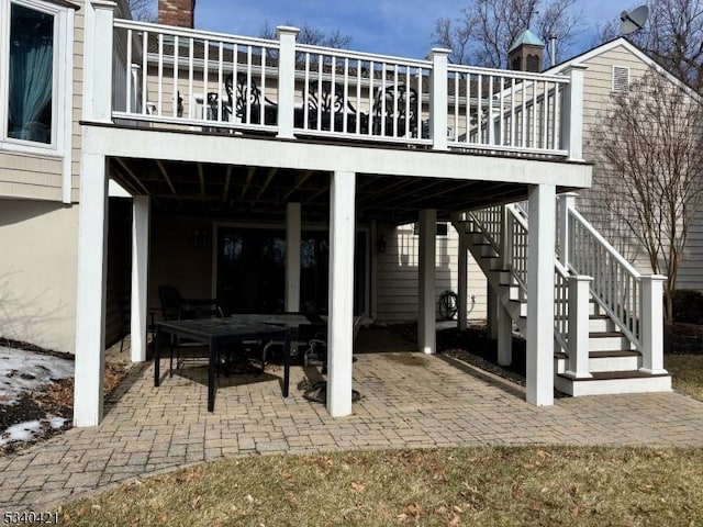 view of patio featuring stairway and a deck