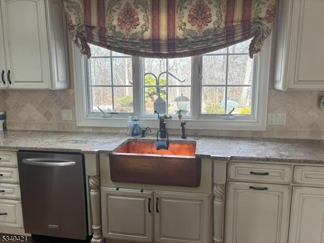 kitchen featuring white cabinets, a sink, backsplash, and dishwasher