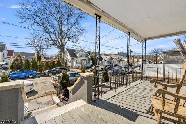 deck with a porch and a residential view