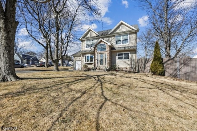 view of front of house with a front lawn and fence