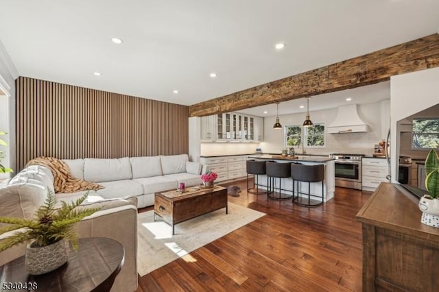 living room with dark wood-type flooring and recessed lighting