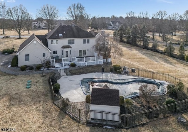 rear view of house featuring a patio area, fence, and a fenced in pool