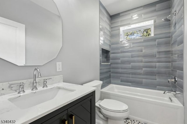 bathroom with washtub / shower combination, vanity, and toilet