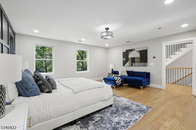 bedroom with recessed lighting, baseboards, and light wood finished floors