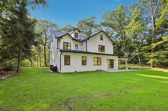 back of property featuring cooling unit, a lawn, and a patio