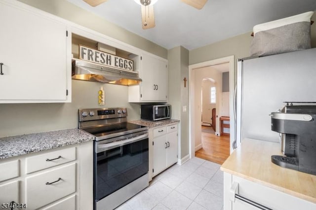 kitchen featuring arched walkways, white cabinets, a ceiling fan, appliances with stainless steel finishes, and under cabinet range hood