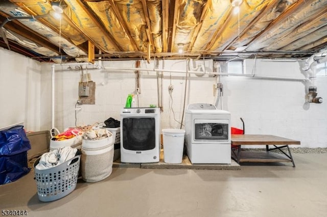 unfinished basement with washing machine and clothes dryer