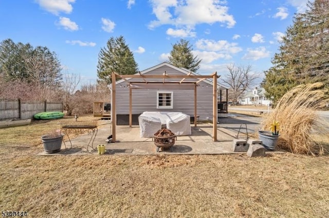 rear view of property featuring an outdoor fire pit, a patio, fence, and a pergola