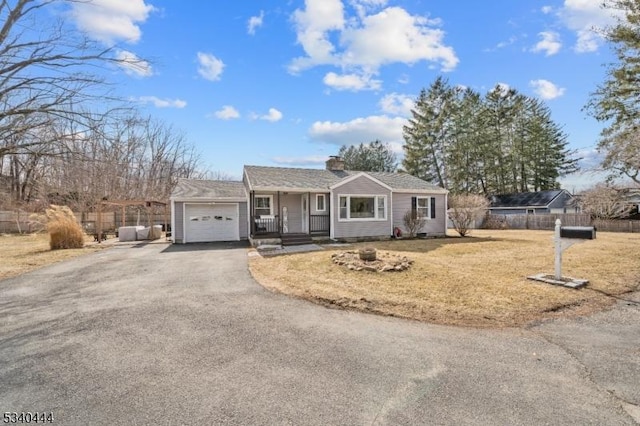 ranch-style house featuring a chimney, fence, a garage, driveway, and a front lawn