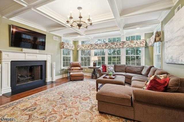 sunroom featuring visible vents, coffered ceiling, a fireplace, beamed ceiling, and a notable chandelier