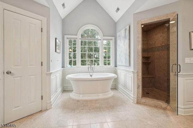 full bathroom with visible vents, a freestanding bath, a wainscoted wall, and a shower stall