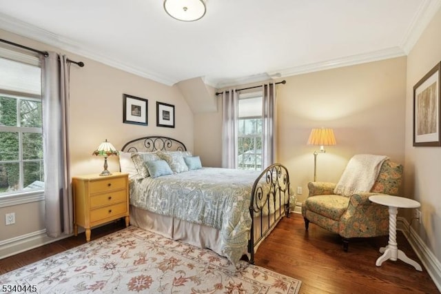 bedroom with crown molding, wood finished floors, and baseboards