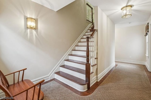 staircase featuring baseboards