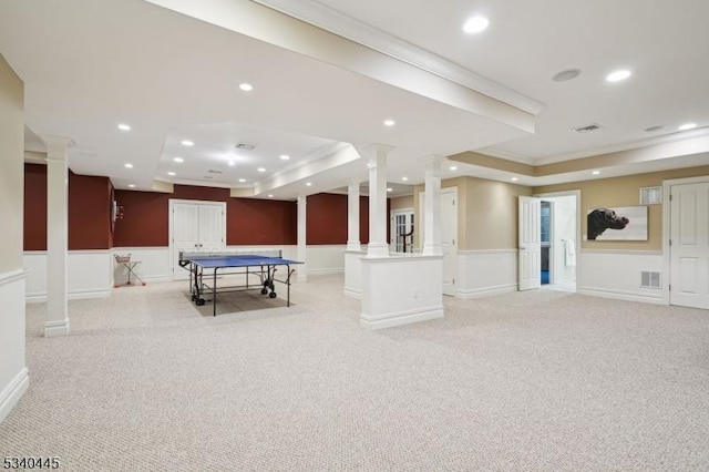 recreation room with light carpet, decorative columns, recessed lighting, and wainscoting