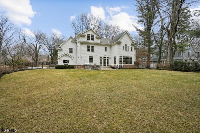 rear view of house featuring a patio and a lawn