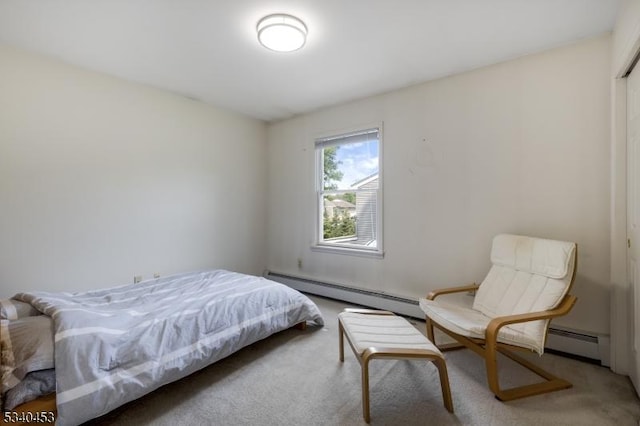 bedroom featuring a baseboard heating unit and carpet flooring