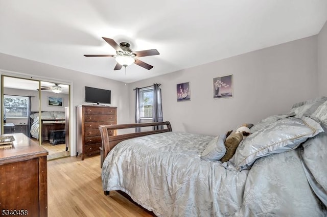 bedroom with light wood-type flooring, a closet, and a ceiling fan