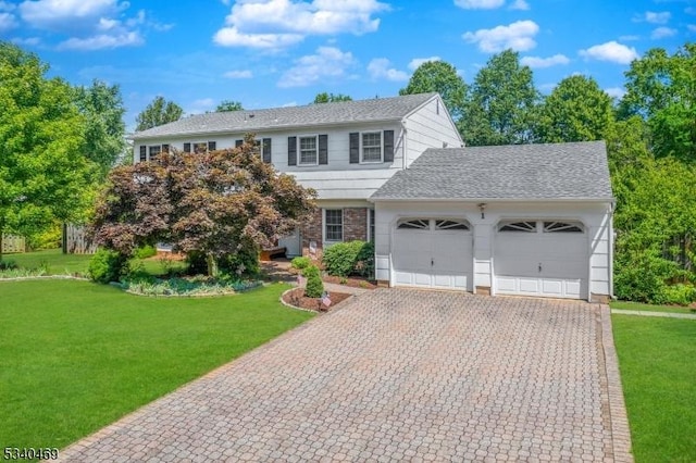 view of front facade with a garage, decorative driveway, roof with shingles, and a front lawn