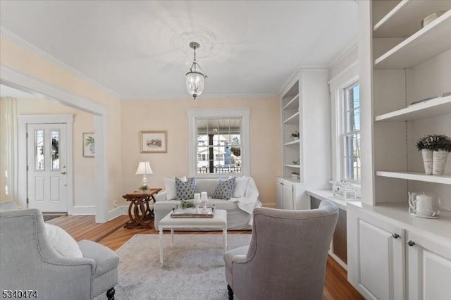 living room with ornamental molding, dark wood-style flooring, and baseboards