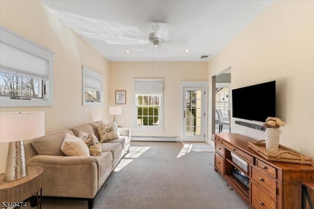 living room with light carpet, baseboard heating, visible vents, and recessed lighting