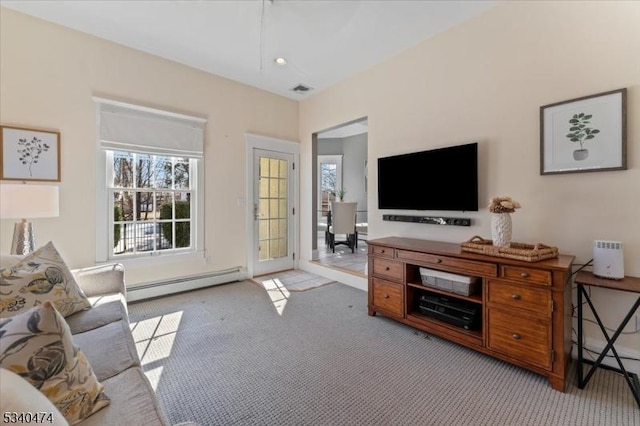 living area featuring carpet floors, baseboard heating, visible vents, and recessed lighting